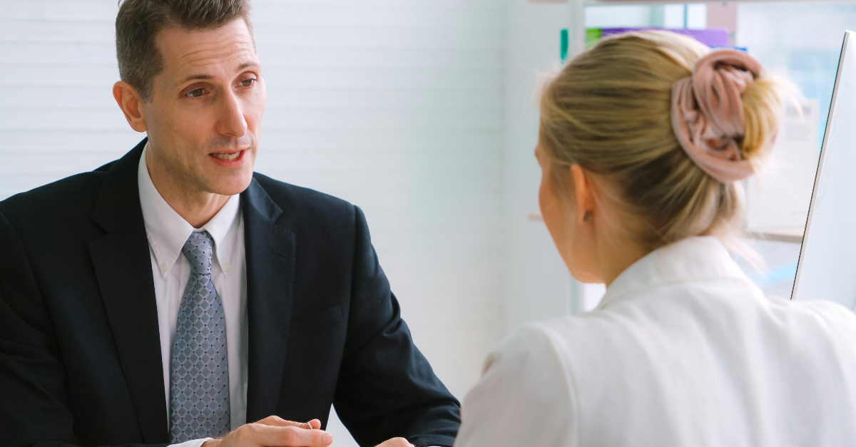 man interviewing a blonde woman